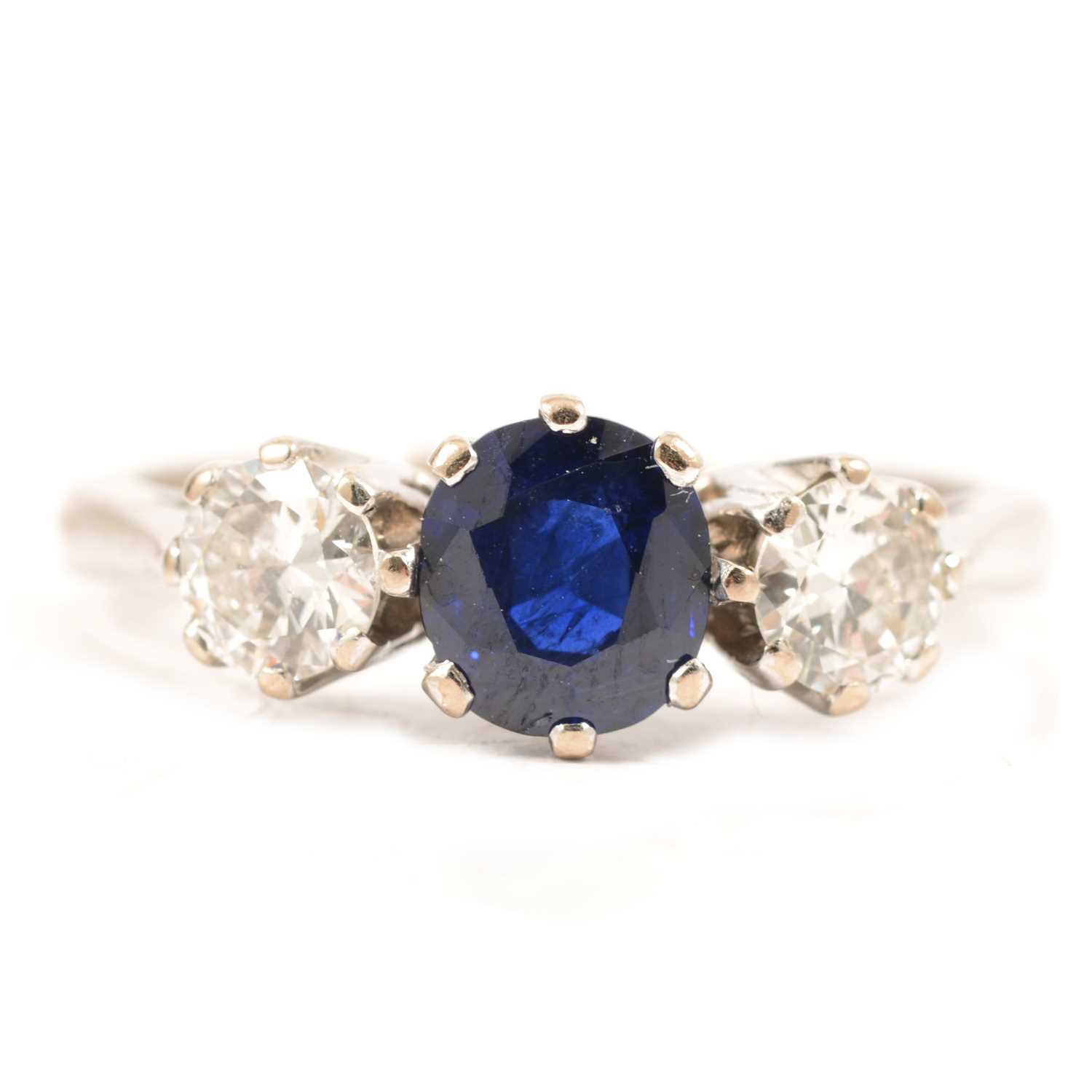 Lot 44 - A sapphire and diamond three stone ring.