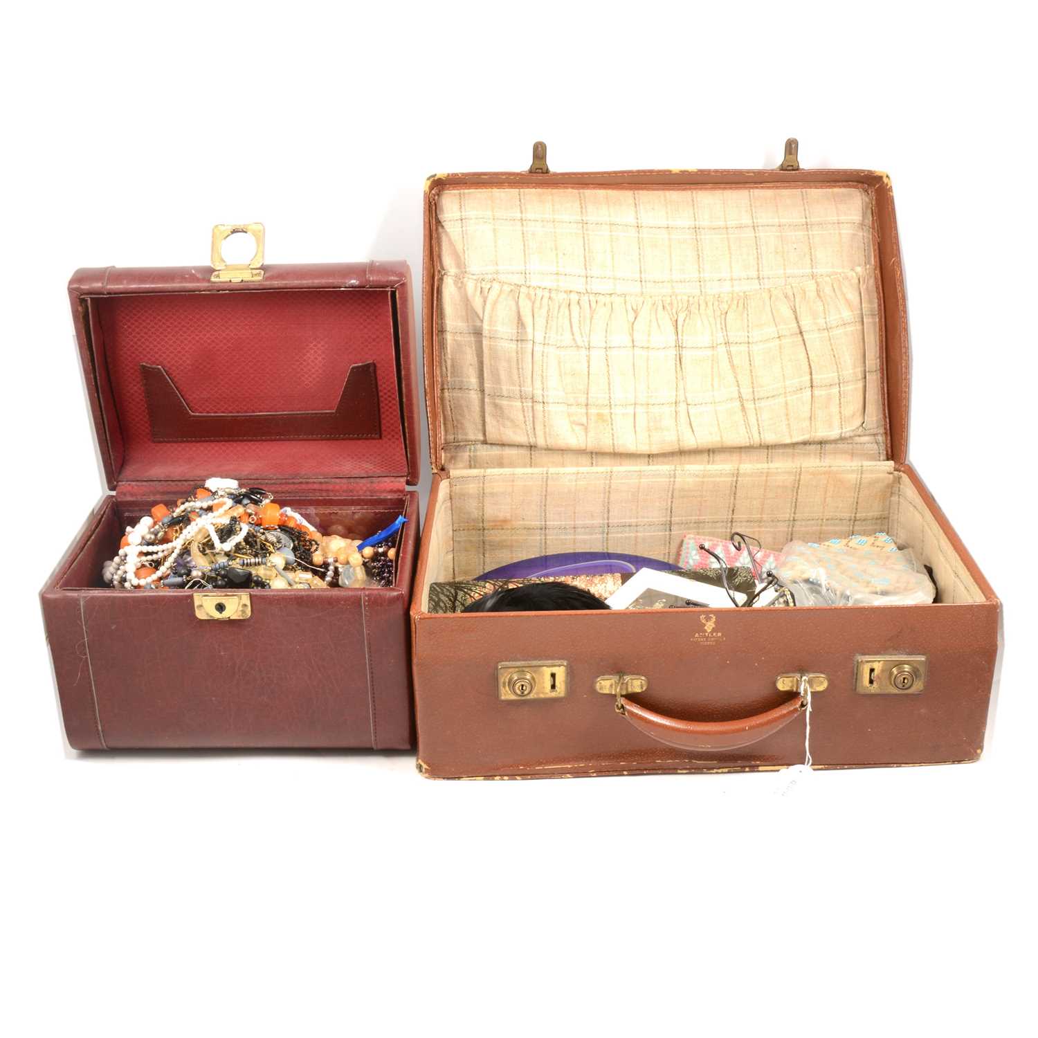 Lot 217 - Costume jewellery necklaces, bracelets, old coins, Astor-Safe jewellery box and vintage suitcase.