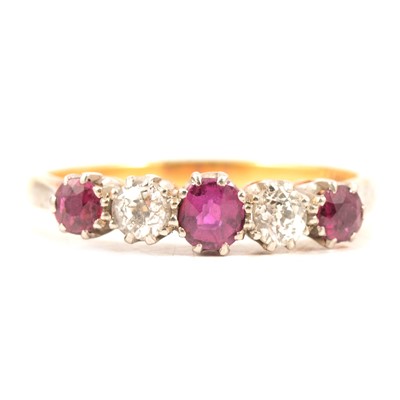 Lot 75 - A ruby and diamond half hoop ring.