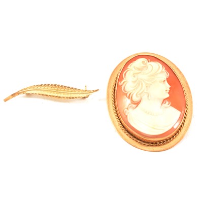 Lot 211 - A gold cameo brooch and a leaf brooch.