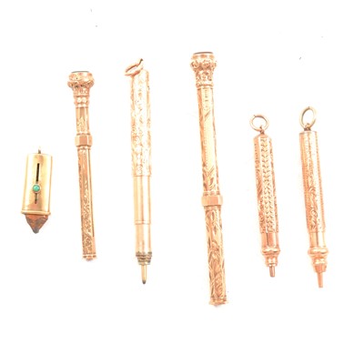 Lot 483 - Five 9 carat yellow gold retractable pencils and a 9 carat yellow gold pencil end cover.