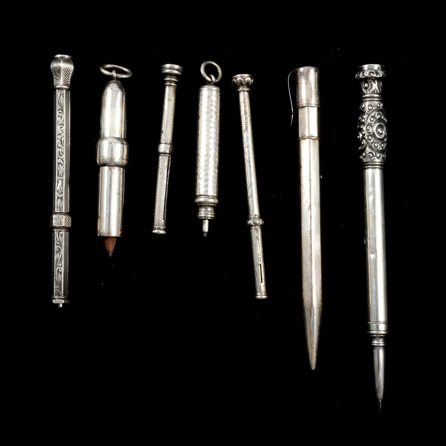 Lot 477 - Seven silver and white metal propelling pencils.