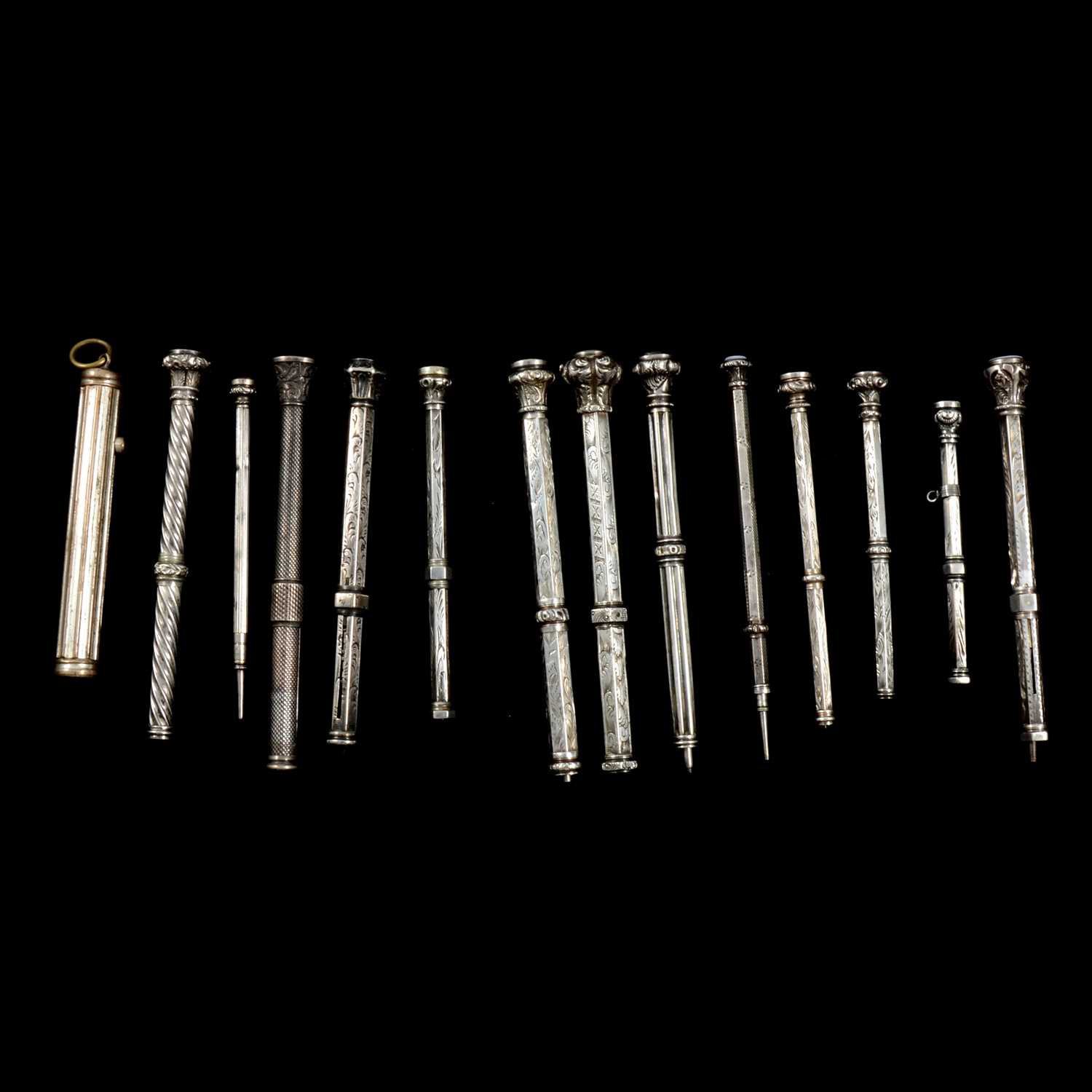 Lot 349 - Fourteen white metal and plated retractable pencils.