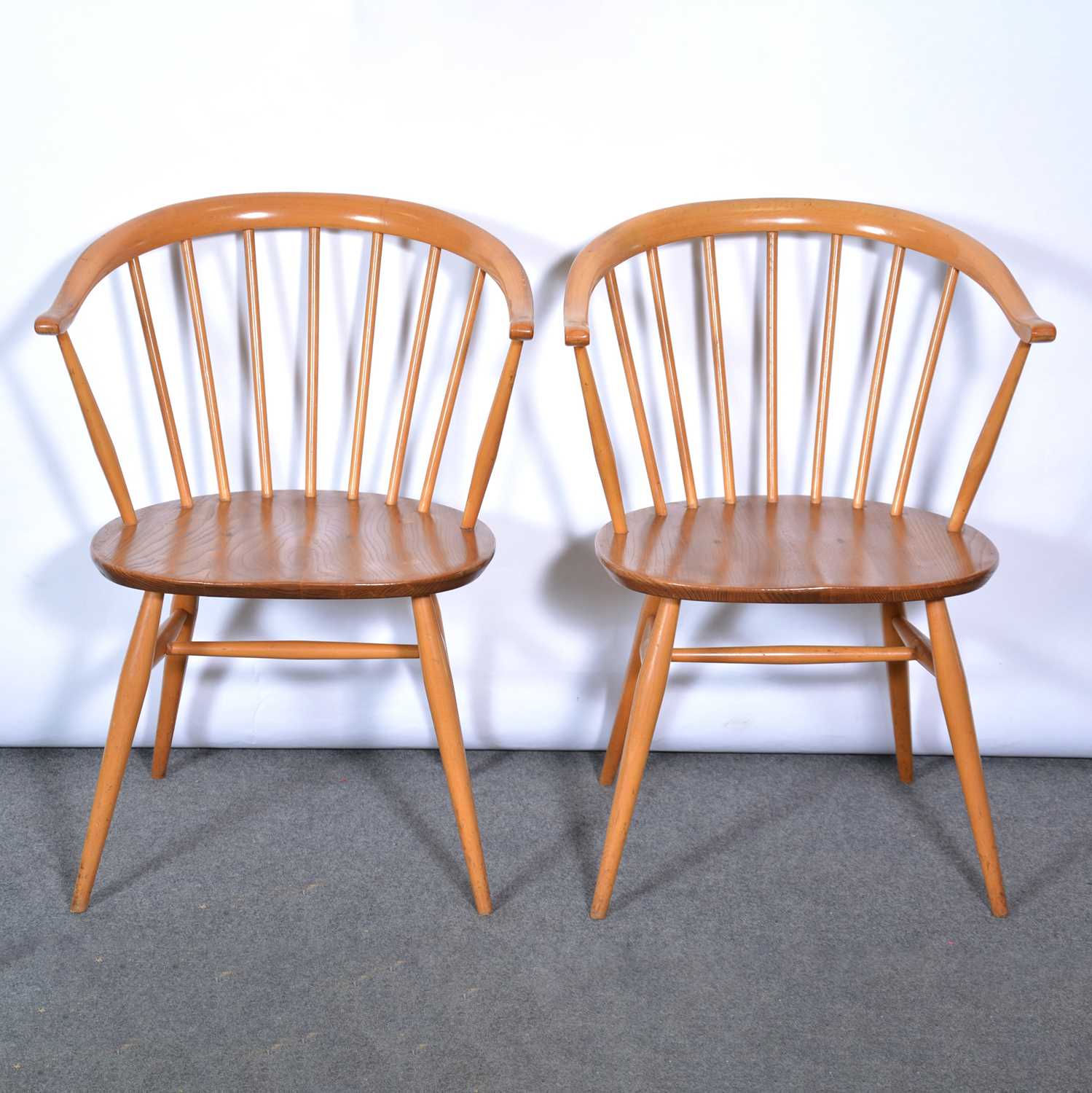 Lot 463 A pair of Ercol 'Cowhorn' elbow chairs