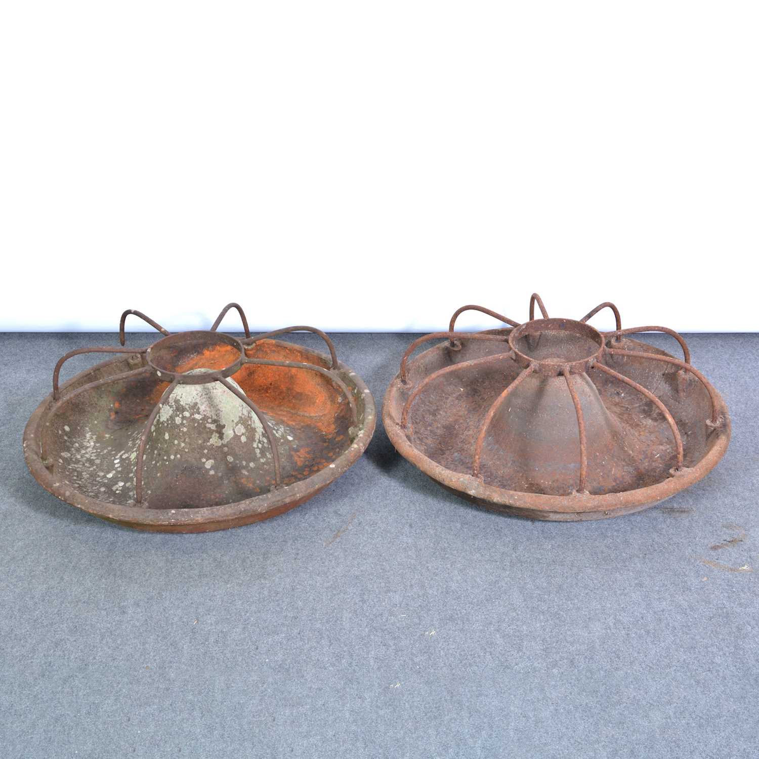 Lot 495 - Two circular cast iron pig feeders