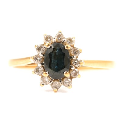 Lot 49 - A sapphire and diamond cluster ring.