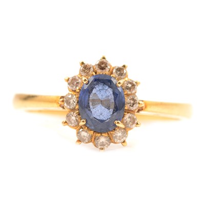 Lot 231A - A sapphire and diamond cluster ring.