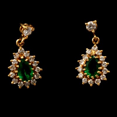 Lot 246 - A pair of emerald and diamond pear shaped cluster earrings.