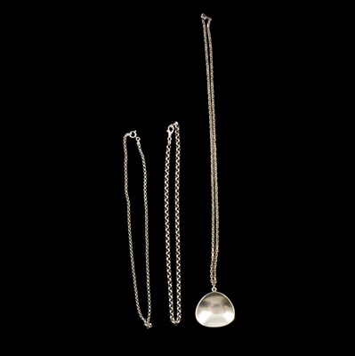 Lot 389 - Bent Knudsen - a Danish silver pendant number 22 and chain and two other chains.