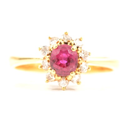 Lot 71 - A ruby and diamond cluster ring.