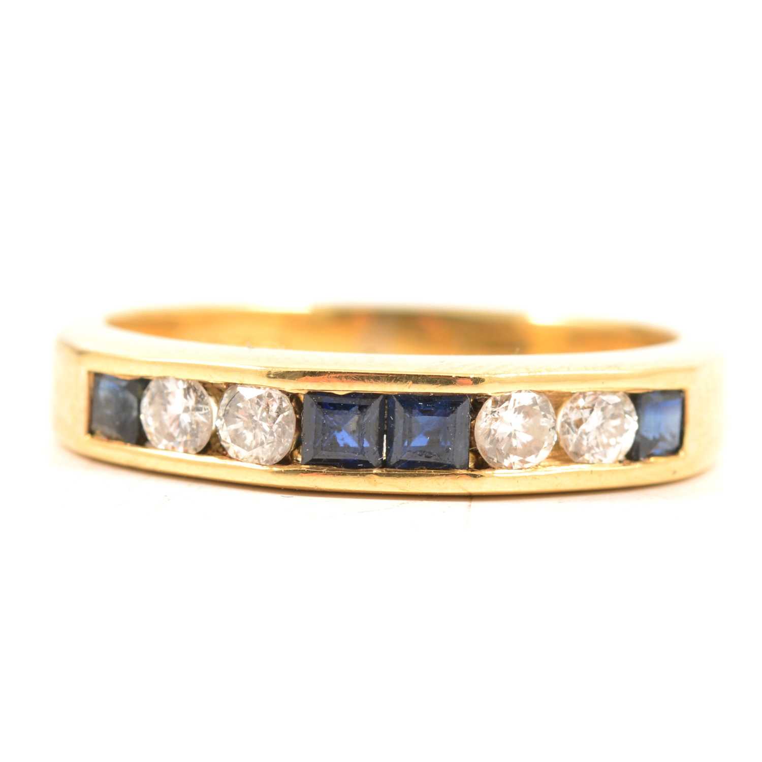 Lot 58 - Two eternity rings, emerald, sapphire and diamond.
