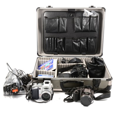 Lot 100A - Three digital cameras and accessories.