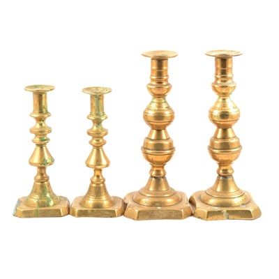 Lot 158 - Two pairs of brass candlesticks.