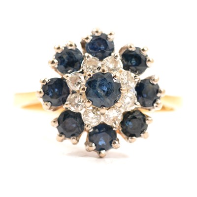 Lot 47 - A sapphire and diamond reverse cluster ring.