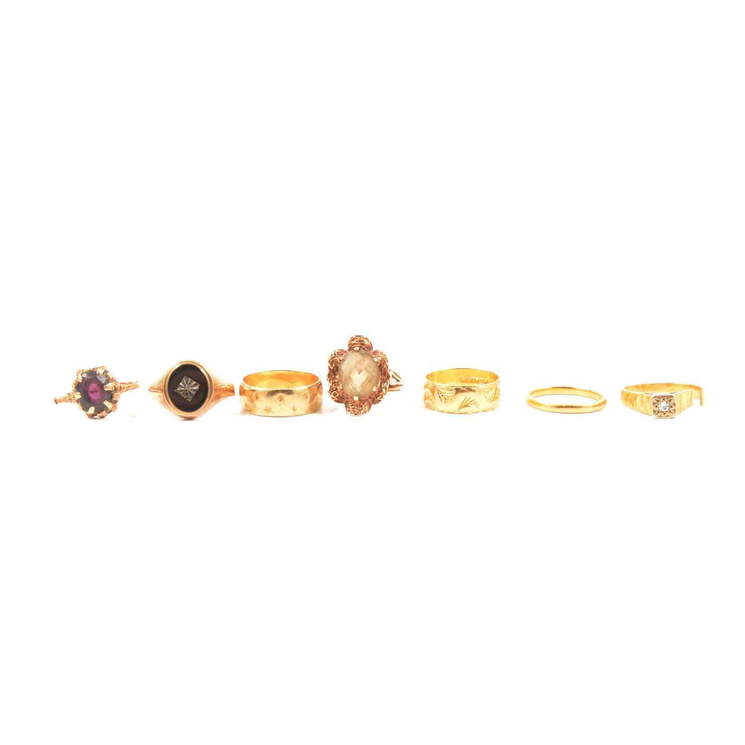 Lot 109 - Three gold wedding bands, and four gem set rings.