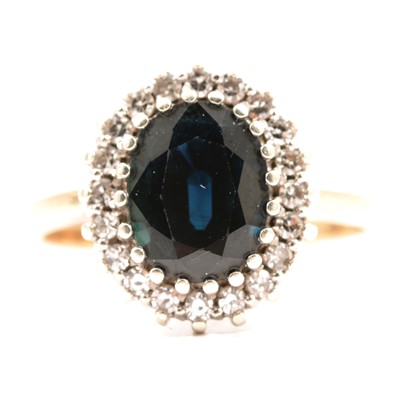 Lot 50 - A sapphire and diamond cluster ring.