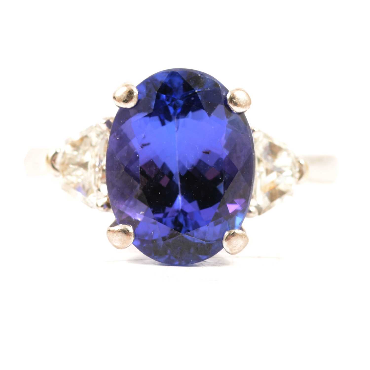 Lot 66 - A tanzanite and diamond three stone ring.