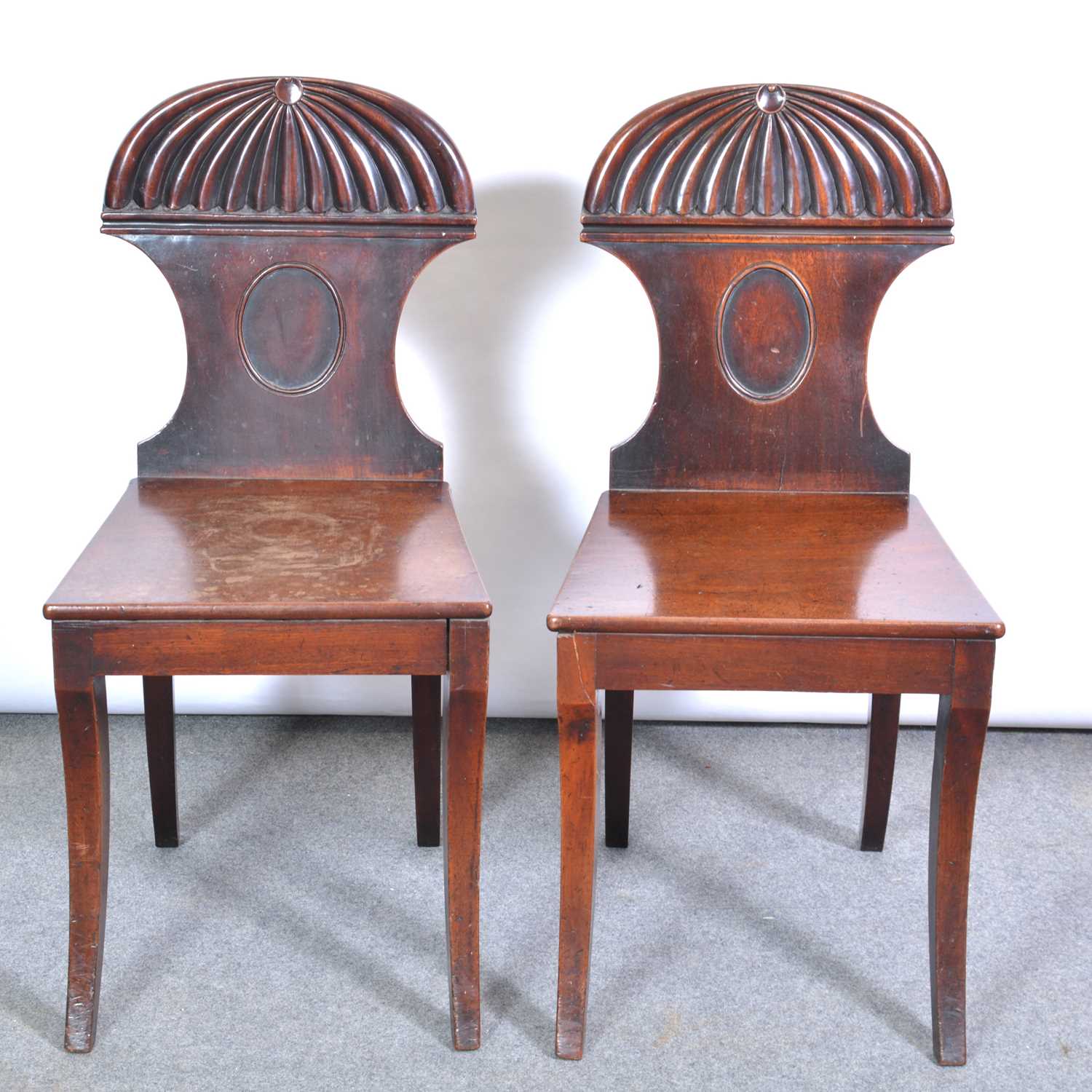 Lot 408 - Pair of George IV mahogany hall chairs,