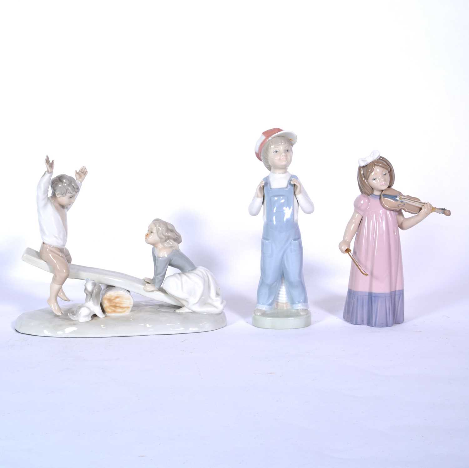 Lot 102 - Two Nao figurines and one Lladro figurine.