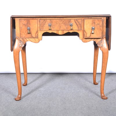 Lot 575 - Reproduction walnut drop leaf lowboy