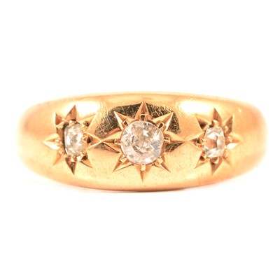 Lot 122 - A star gypsy set three stone diamond ring.