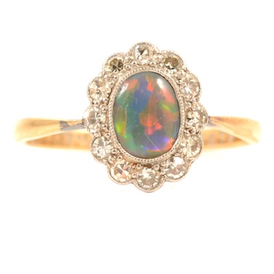 Lot 84 - A black opal and diamond cluster ring.