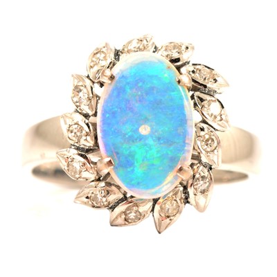 Lot 86 - An opal and diamond cluster dress ring.