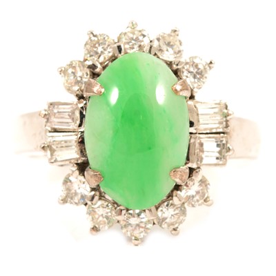 Lot 79 - A jade and diamond cluster ring.