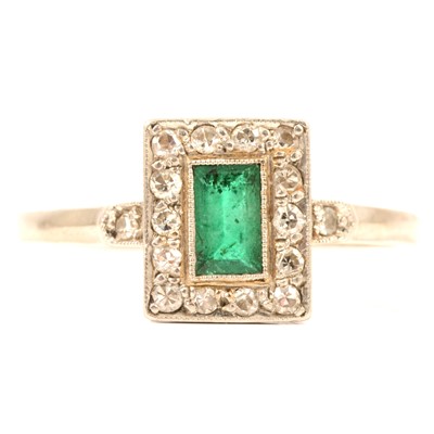 Lot 71 - A rectangular emerald and diamond cluster ring.
