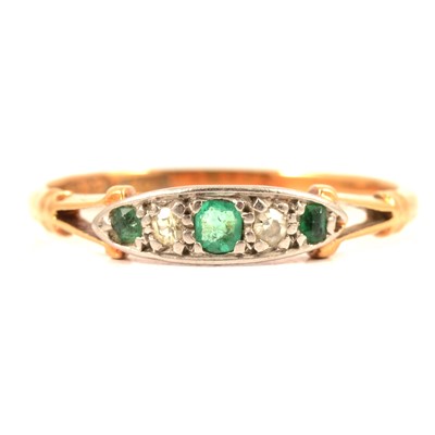 Lot 73 - A small emerald and diamond half hoop ring.