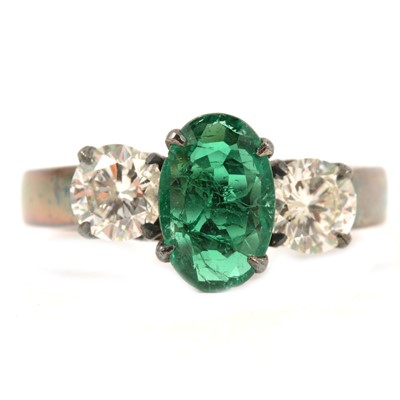 Lot 78 - A synthetic emerald and diamond three stone ring.