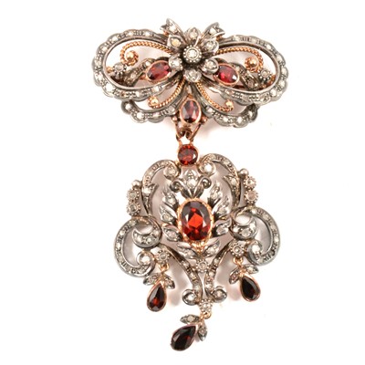 Lot 259 - A garnet and diamond brooch pendant.