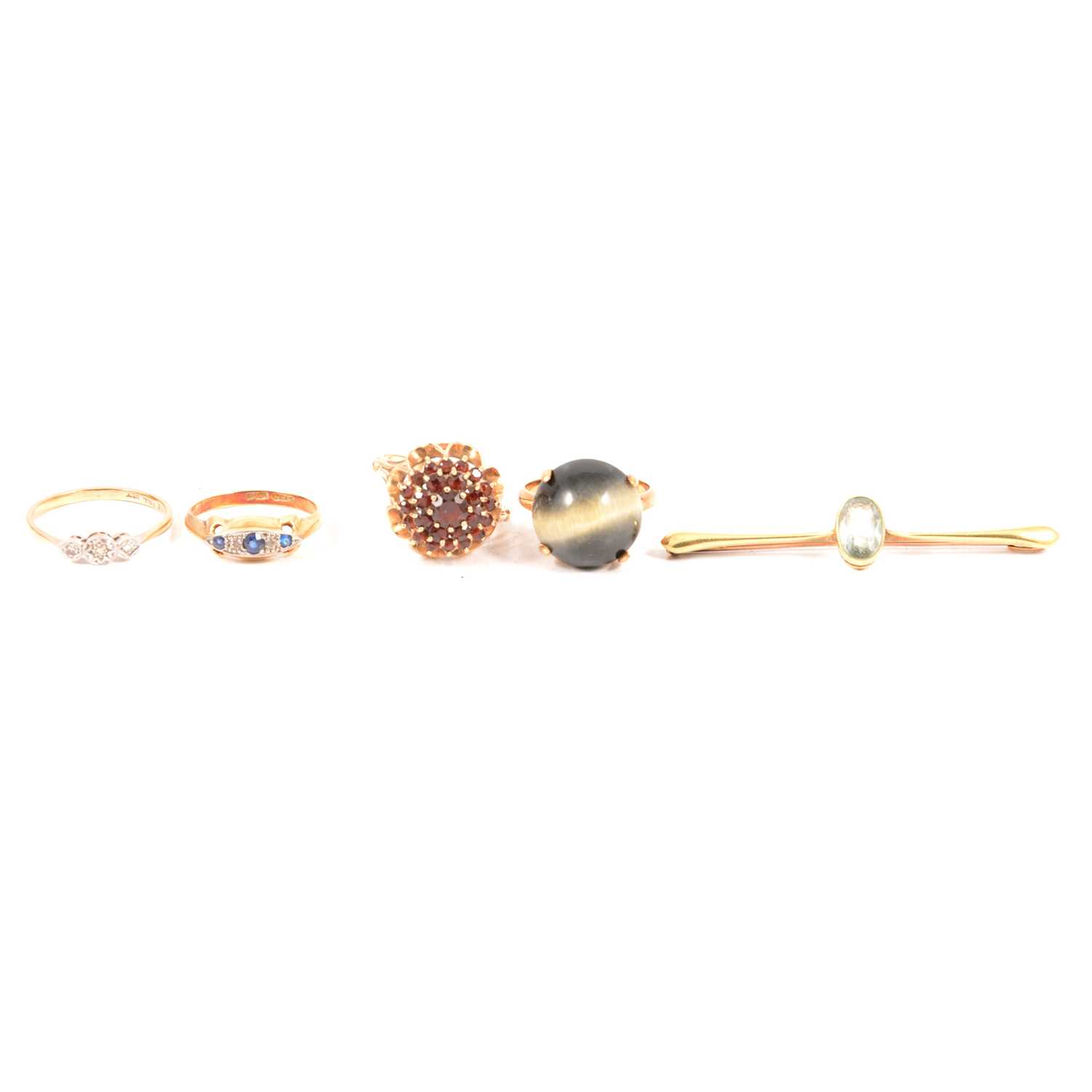 Lot 116 - Four gemset rings and a yellow metal bar brooch.