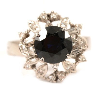 Lot 318 - A contemporary sapphire and diamond cluster ring.