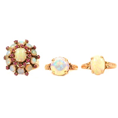 Lot 92 - Three opal rings, two solitaires and one a cluster with rubies.