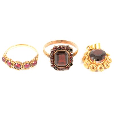 Lot 107 - Two garnet dress rings and a pendant.