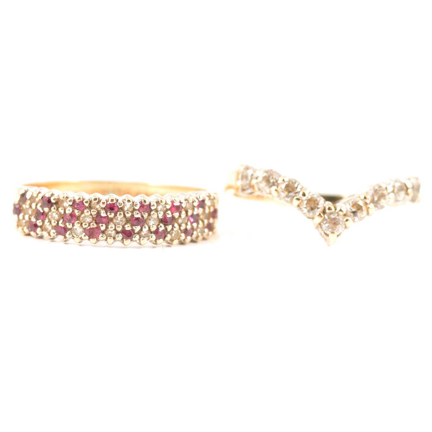 Lot 234 - A ruby and diamond half hoop ring, a