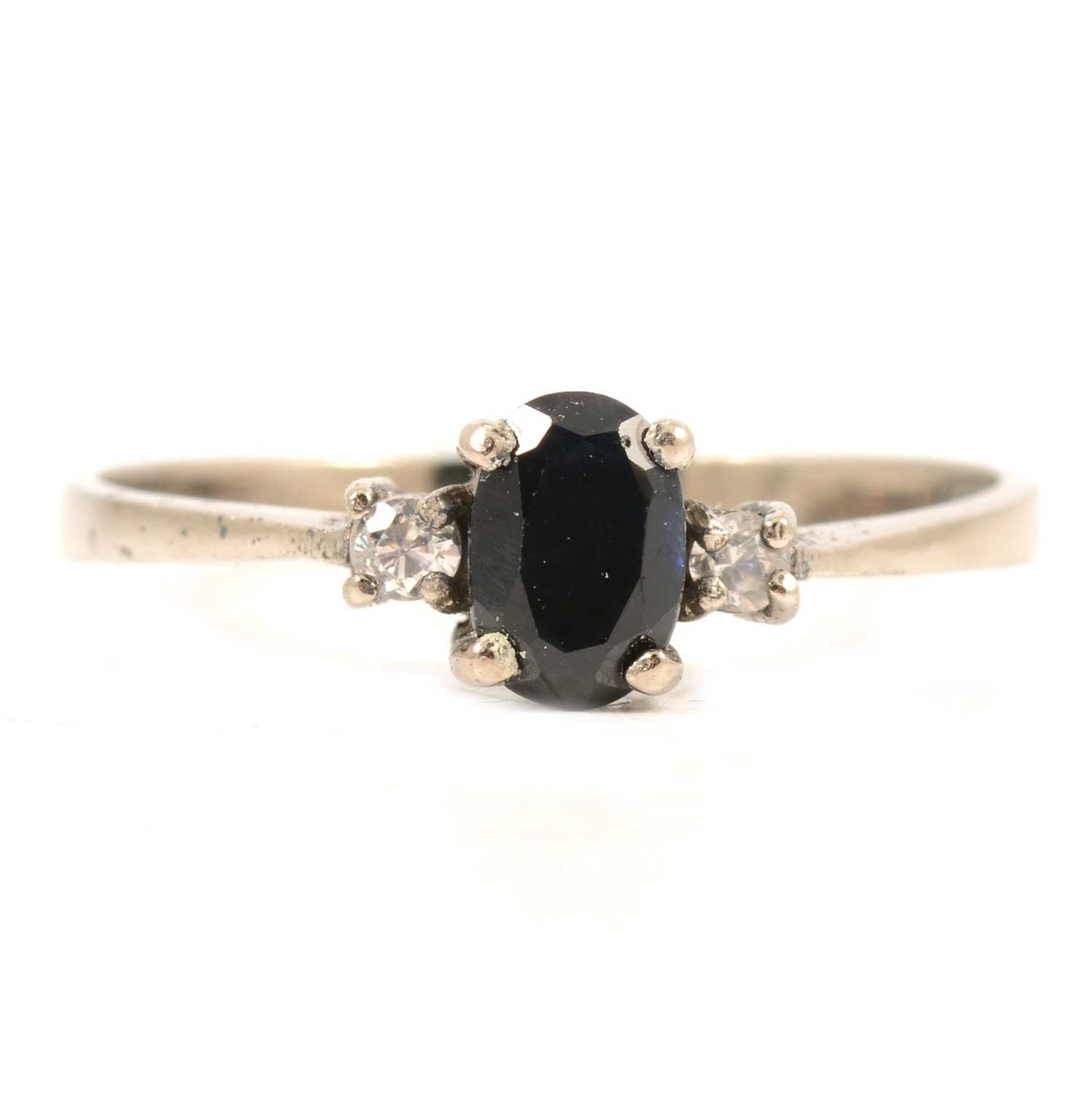 Lot 50 - A sapphire and diamond three stone ring.