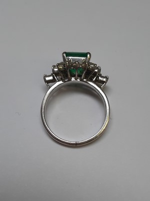 Lot 72 - An emerald and diamond ring.