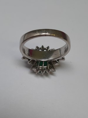 Lot 72 - An emerald and diamond ring.