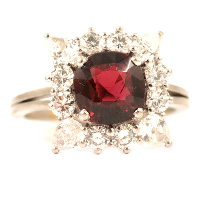 Lot 104 - An almandine garnet and diamond cluster ring.