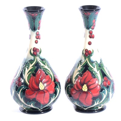 Lot 15 - Moorcroft Pottery - a pair of Ruby pattern bottle vases.