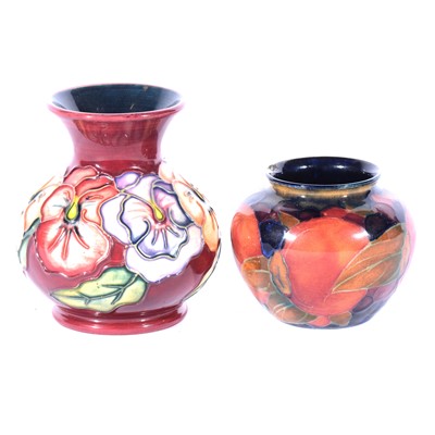 Lot 25 - Moorcroft Pottery - a small Pomegranate pattern vase, and a modern Pansy pattern vase.