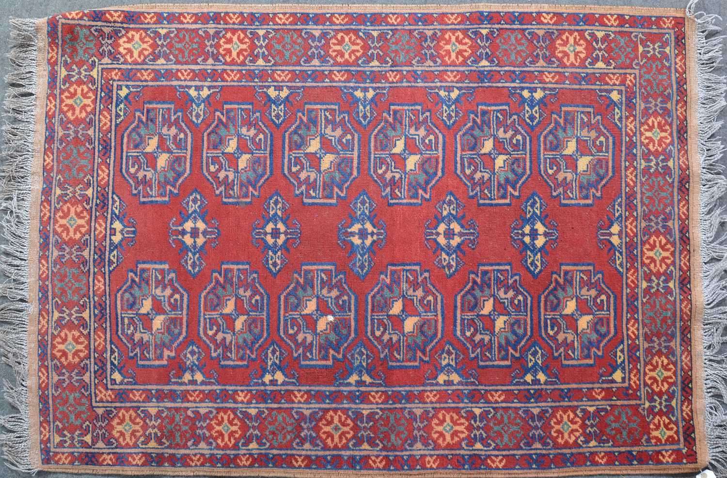 Lot 579 - Persian rug, two rows of guls