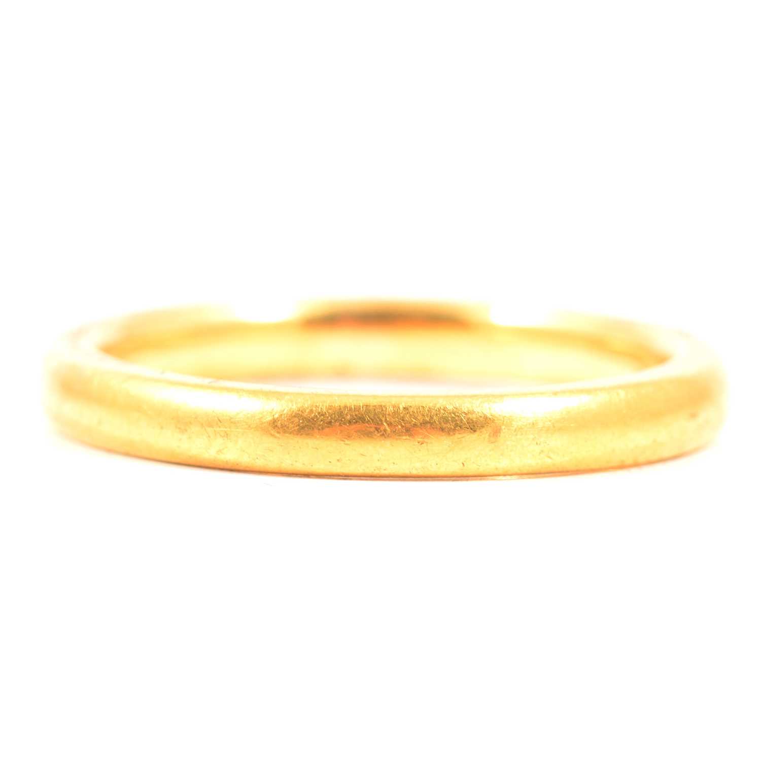 Lot 138 - A 22 carat yellow gold wedding band.