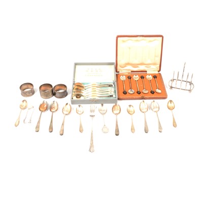 Lot 204 - A cased set of silver bean top coffee spoons, silver toast rack, three napkin rings, plated ware.