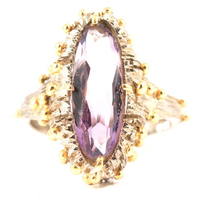 Lot 98 - A handmade 18 carat white and yellow gold ring set with amethyst.