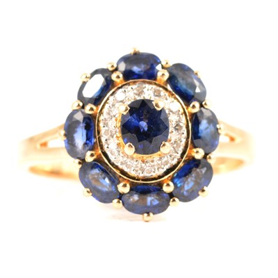 Lot 231 - A blue stone and diamond cluster ring.