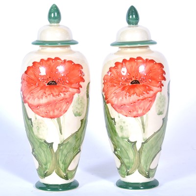 Lot 70 - A pair of 'Poppy' design lustre covered vases by Lise B Moorcroft