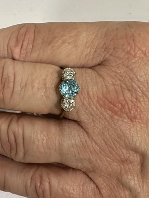 Lot 82 - A heat treated blue zircon and diamond three stone ring.